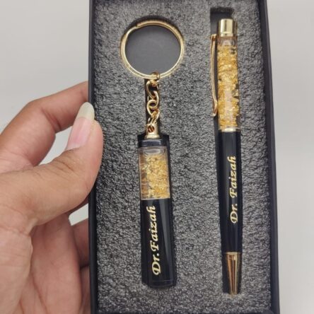 Personalized Pen & Keychain Gifts with Name Engraving | Pen for Gifting | Gift Set for Men & Women, Co Brand	blinkNshop Writing instrument form	Ballpoint Pen Colour	Black Ink Colour	Black Age Range (Description)	Adult About this item PRODUCT DETAILS:- Material: Metallic || Color: Black & Golden || Item Dimension: 3.25 x 6.25 Inch || Package Contain: Pack of 2 || To Customise Your Gold Flake Set Contact The Seller Trough "Seller Messaging Assistant" Under the 'Buyer-Seller Messaging Service. PRODUCT INCLUDED:- Customized gift set with pen with a keychain with your name Engraved on it. FOR GIFT:- Office Supplies, Corporate , anniversary gift, etc. Versatile Use: Ideal for on-the-go writing needs or as an emergency pen. Dual Functionality: Serves as both a reliable writing tool and a handy keychain accessory.rporate Gift Set, Customized Birthday Gift for Husband/Boyfriend/Brother/Wife - Image 4