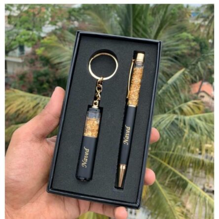 Personalized Pen & Keychain Gifts with Name Engraving | Pen for Gifting | Gift Set for Men & Women, Co Brand	blinkNshop Writing instrument form	Ballpoint Pen Colour	Black Ink Colour	Black Age Range (Description)	Adult About this item PRODUCT DETAILS:- Material: Metallic || Color: Black & Golden || Item Dimension: 3.25 x 6.25 Inch || Package Contain: Pack of 2 || To Customise Your Gold Flake Set Contact The Seller Trough "Seller Messaging Assistant" Under the 'Buyer-Seller Messaging Service. PRODUCT INCLUDED:- Customized gift set with pen with a keychain with your name Engraved on it. FOR GIFT:- Office Supplies, Corporate , anniversary gift, etc. Versatile Use: Ideal for on-the-go writing needs or as an emergency pen. Dual Functionality: Serves as both a reliable writing tool and a handy keychain accessory.rporate Gift Set, Customized Birthday Gift for Husband/Boyfriend/Brother/Wife